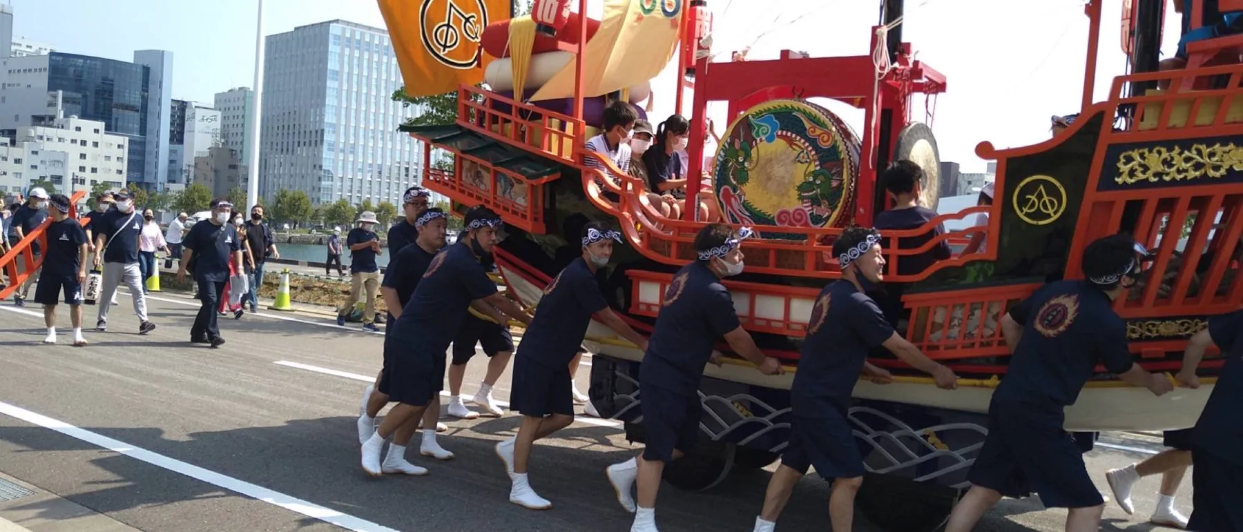 力を合わせて御朱印船を押す人たち