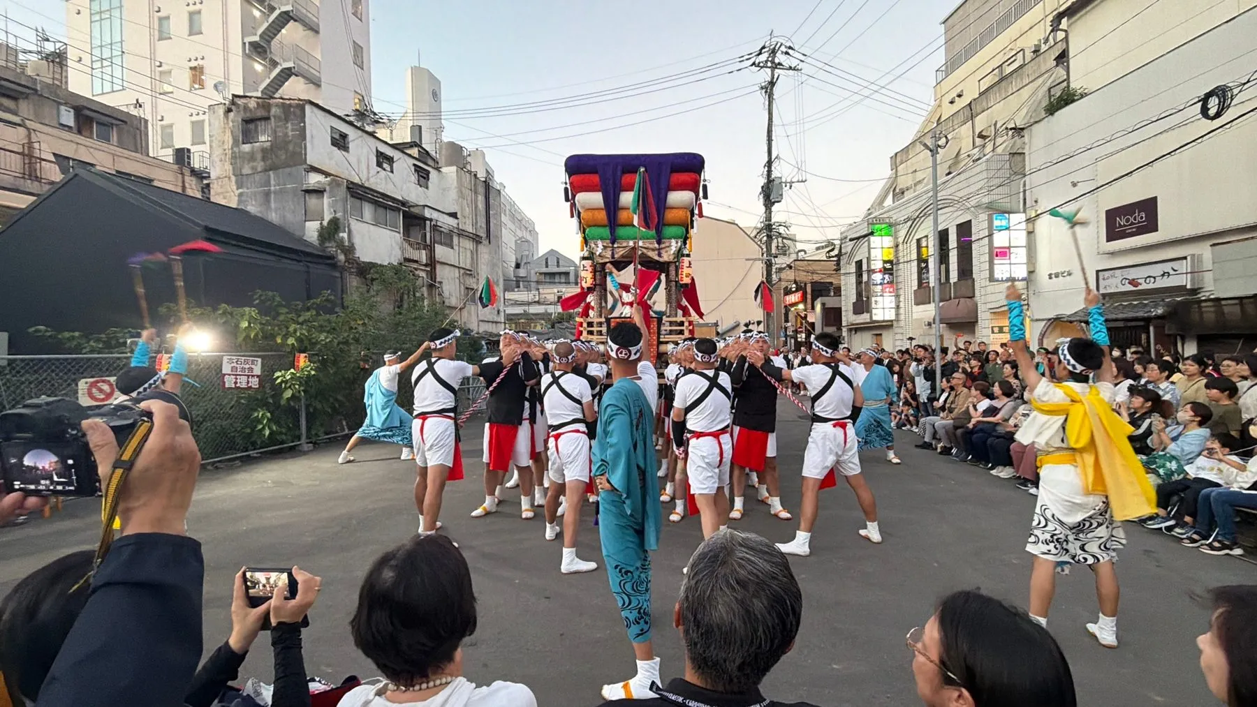 通りで担がれる太鼓山と、見物の人たち